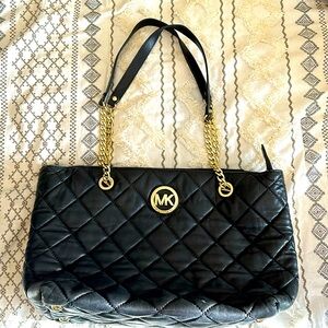 Black Michael Kors purse with gold embellishment. Amazing condition.